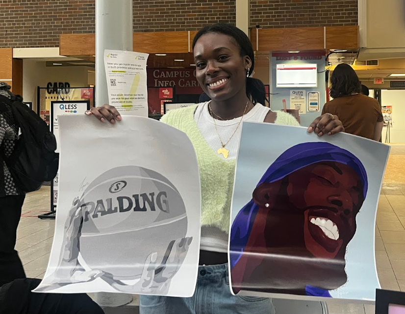 Artist holding up paintings they have created