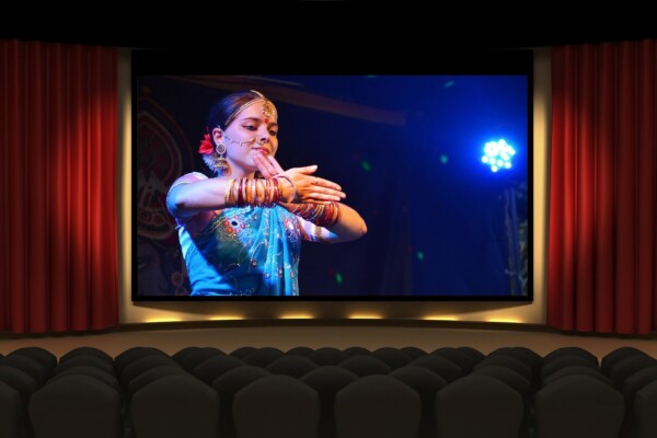 bollywood movie on a move screen in a theatre.