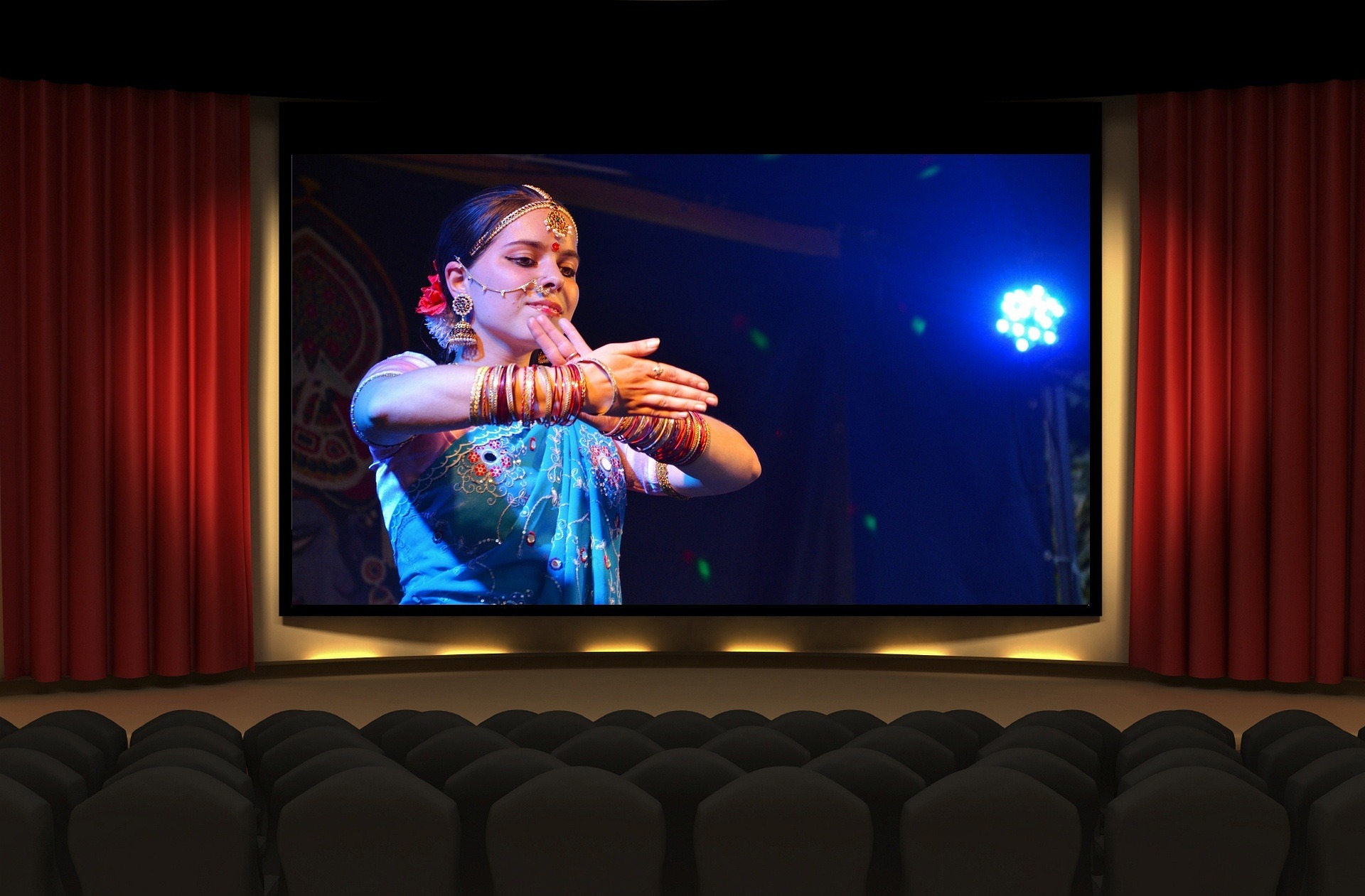 bollywood movie on a move screen in a theatre.