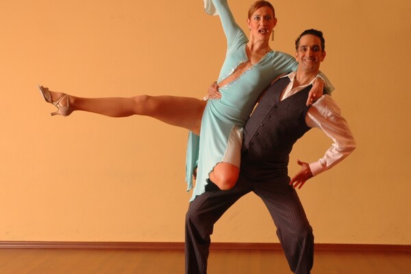 a woman being held in the air by her dance partner.