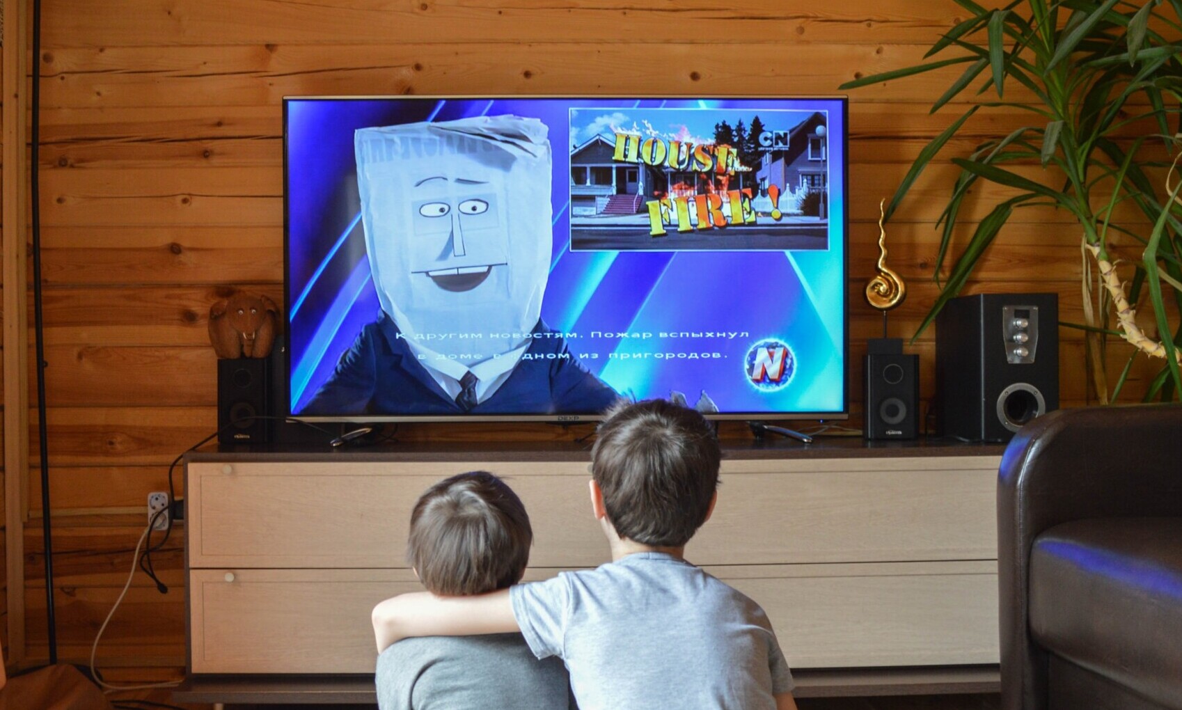 two young kids watching tv