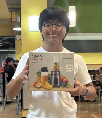 Student displaying their bingo prize: Personal Blender.