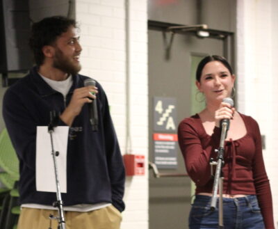 Two students with microcu_people_phones singing karaoke.