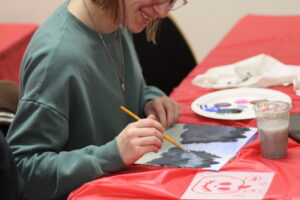One student painting their canvas.