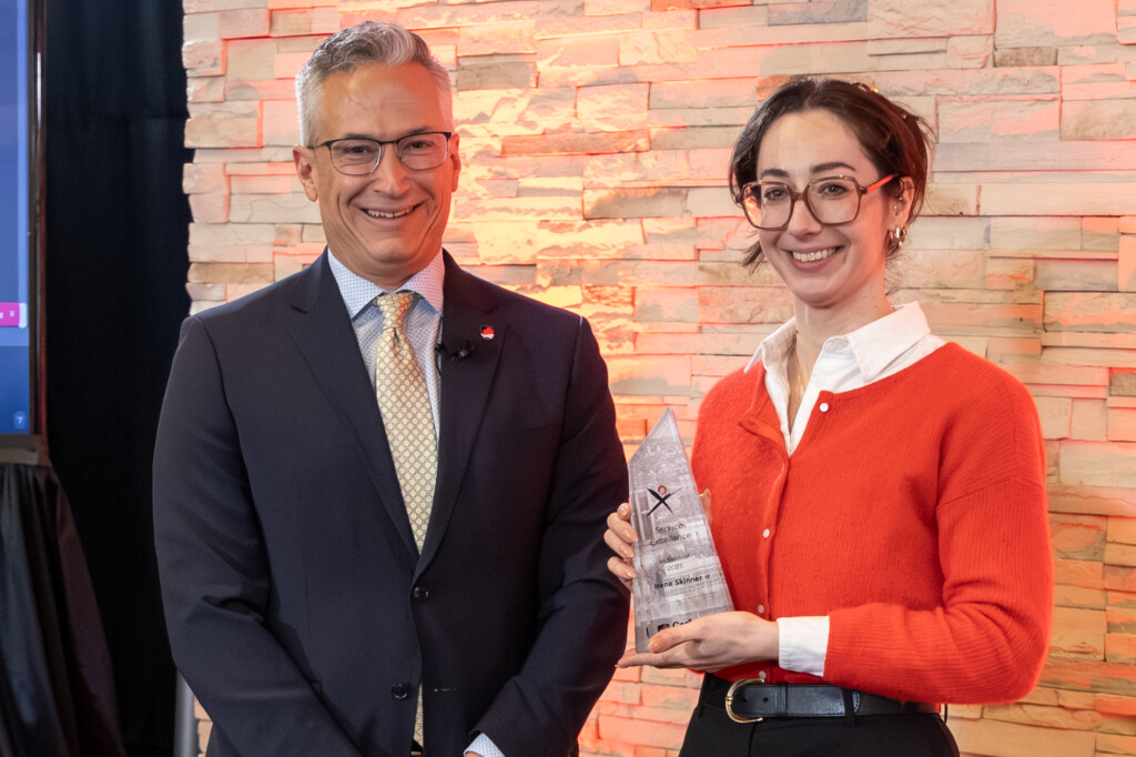 Erin Chezick accepting the award on behalf of Irene Skinner and Duane McNair