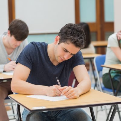 student writing an exam