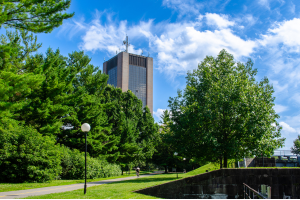 Dunton Tower spotted over trees from the Rideau Canal