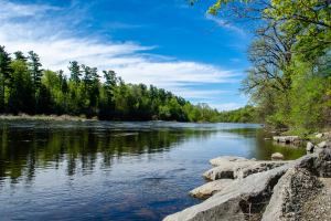 A large river with rocks in the foreground