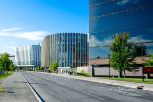 Three large glass buildings on an empty road