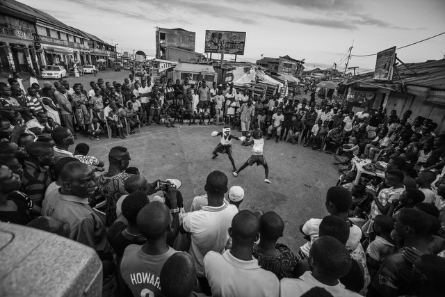 Young boxers square off in the street at Wato Junction in downtown Accra, Ghana. Sunday night street fights are a longstanding tradition of the Bukom boxing community.