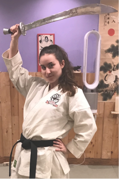 Anna in her gi holding a sword