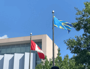 Deaf flag flying alongside Canadian flag