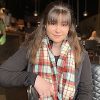 Sarah Donnelly in a restaurant wearing a tartan scarf.