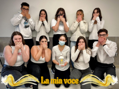 Italian 1020 plus group posing in white shirts with their hands over their mouths