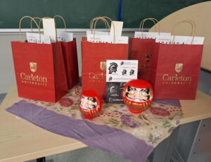 Prize bags and red daruma carvings.