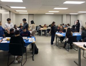 Wide shot of people in the room.