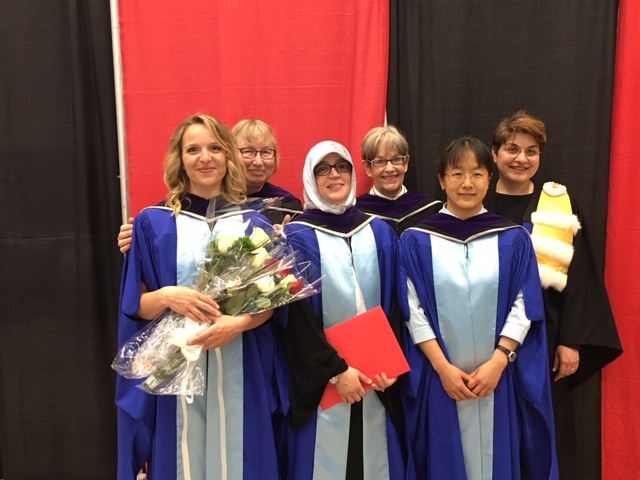 Chloe, Natasha, Nwara, Janna, Lin, and Eva in their graduation robes