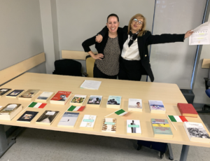 Marcella and Debra standing at the book collection table.