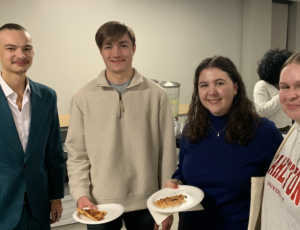 Group of students enjoying pizza