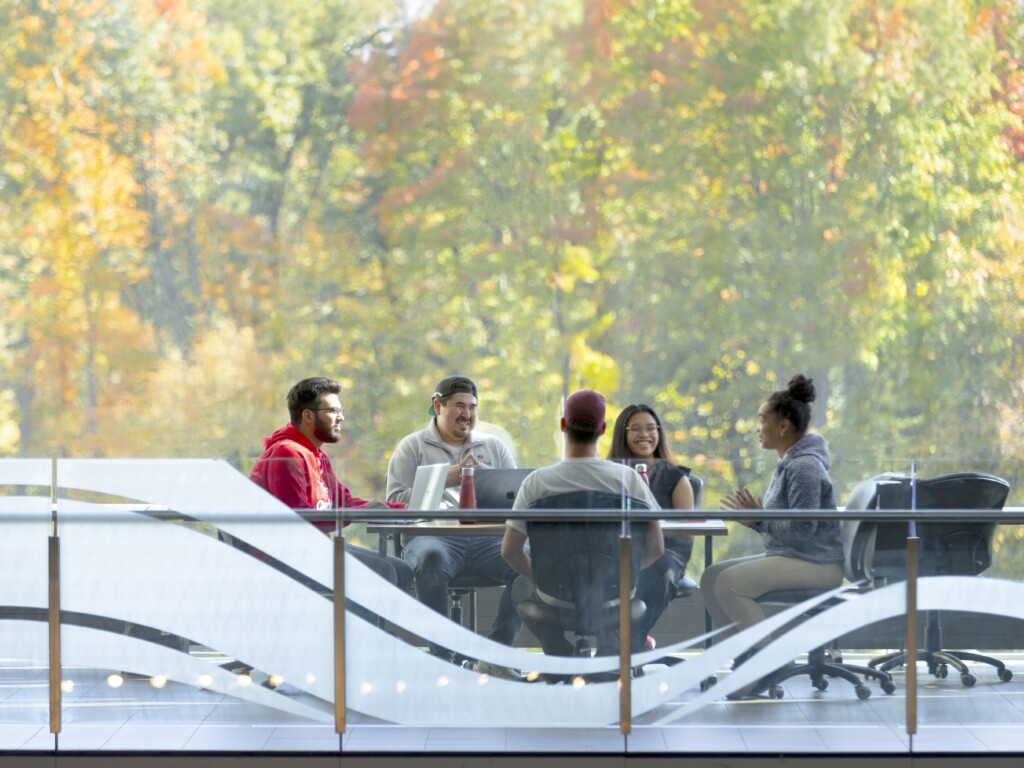 Image of students sitting at a table in Richcraft Hall at Carleton University