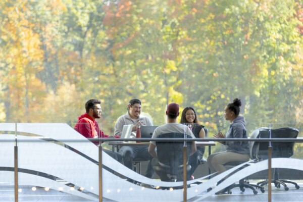 Image of students sitting at a table in Richcraft Hall at Carleton University