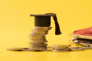 Image of stack of coins with graduation cap on top
