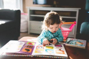 Image of an infant reading a book