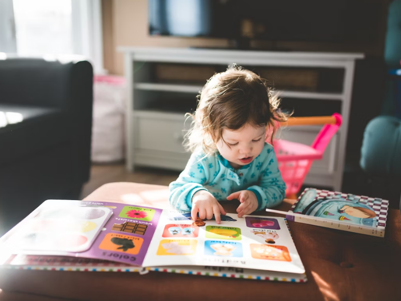 Image of an infant reading a book