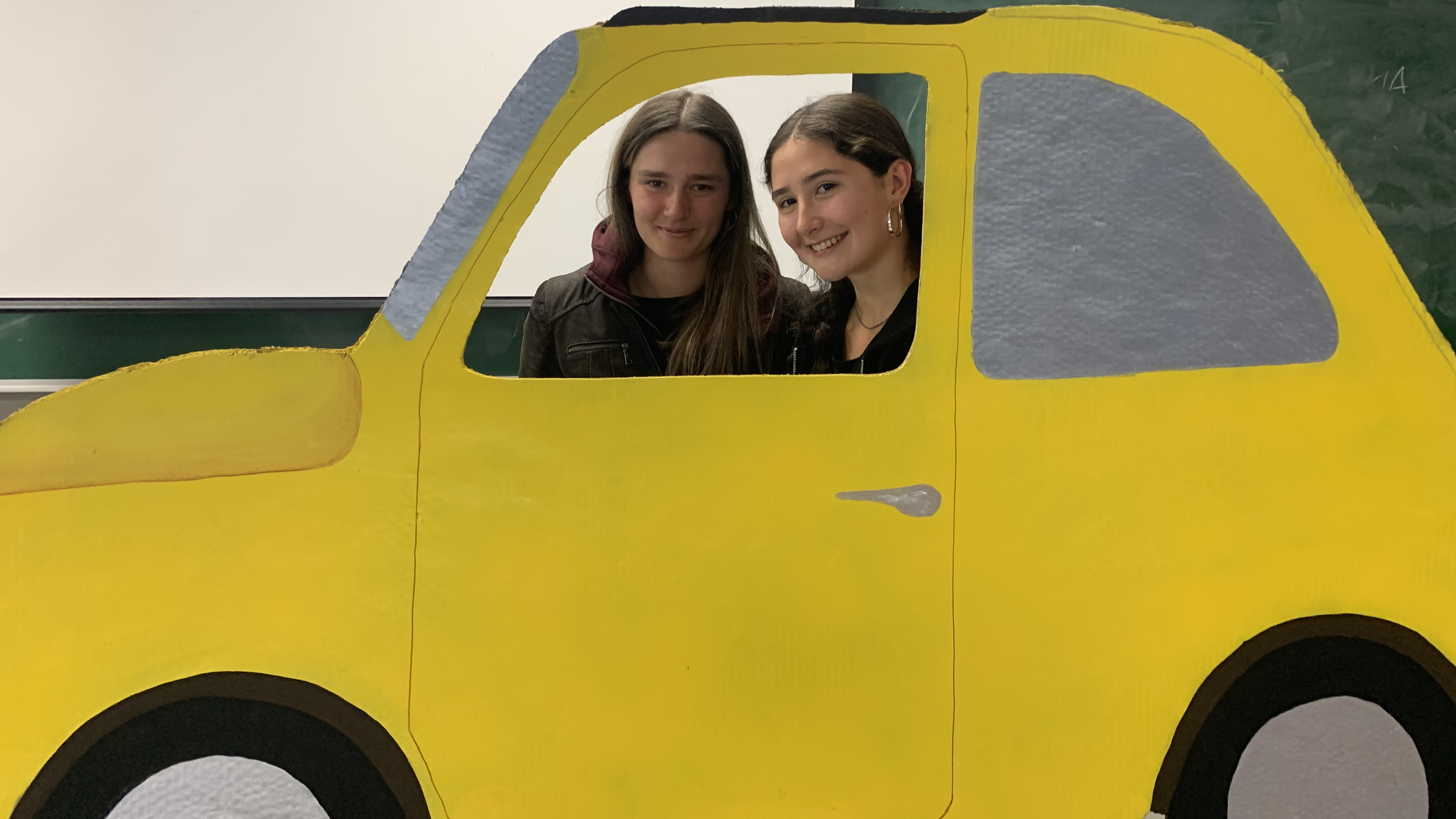 Students in yellow Fiat 500 prop