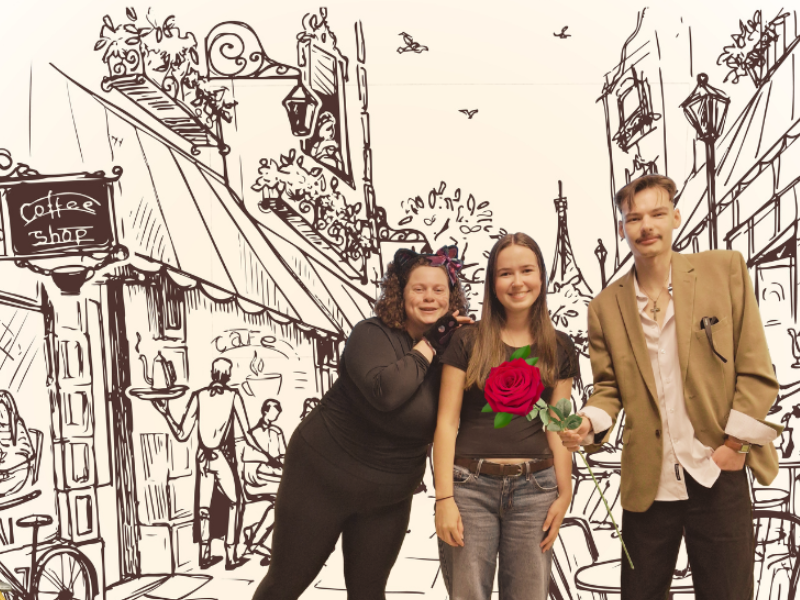 Image of three people standing in front of a street scene that has been sketched