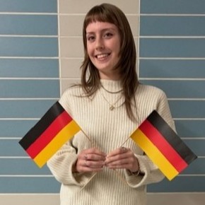 Image of Maggie holding two German flags