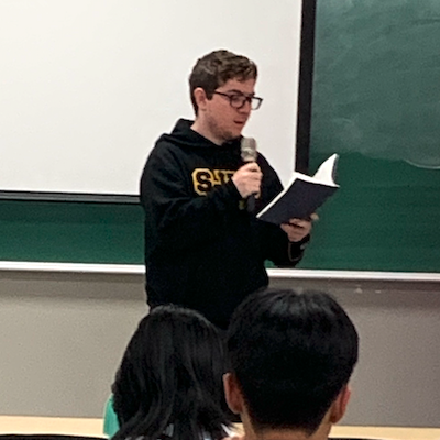 Student reciting poem at Hangeul Day event on October 10