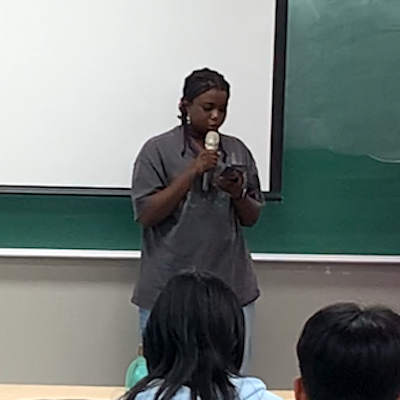 Student reciting poem at Hangeul Day event on October 10