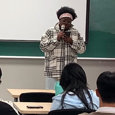 Student reciting poem at Hangeul Day event on October 10