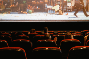 Theatre seats with a movie on the screen