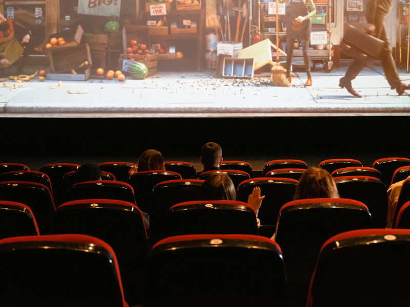 Theatre seats with a movie on the screen