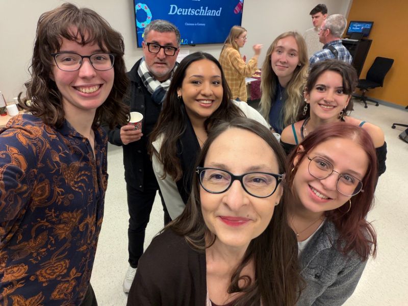 German language instructor Cristina Finger with students at Adventskaffee on November 28, 2025