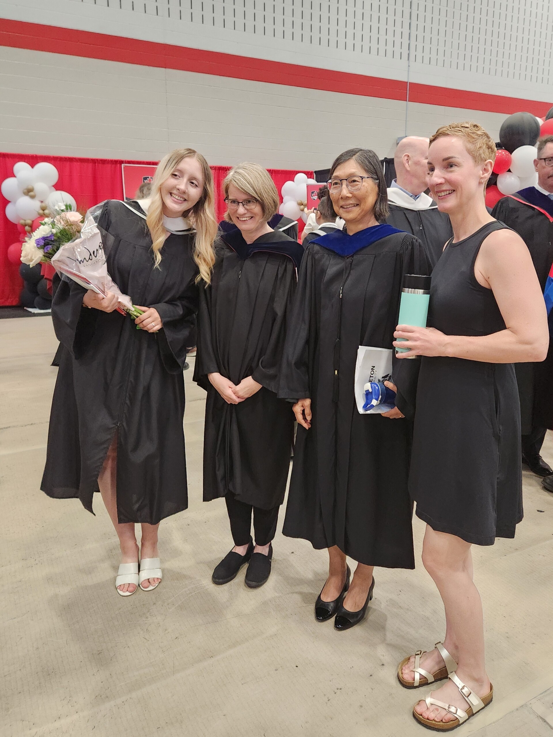 Image of a graduate, Holly, with professors Karen Jesney, Kumiko Murasugi, and Beth MacLeod at convocation