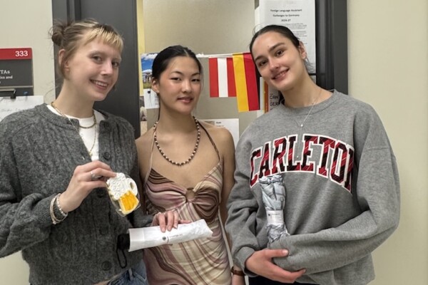 Maggie, Mia, and Clara pose in front of the German office