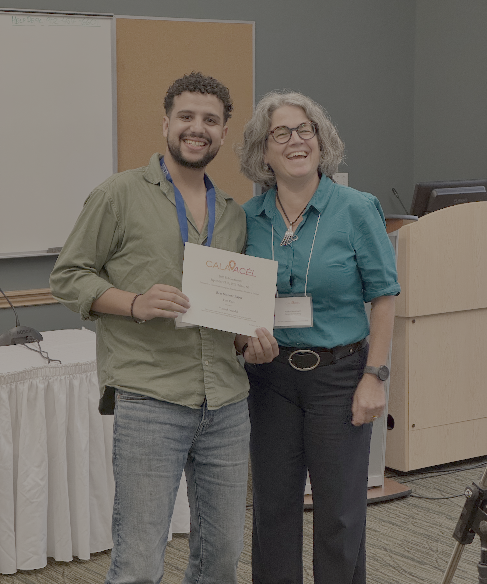 Youssef poses with certificate alongside Heike Neumann.