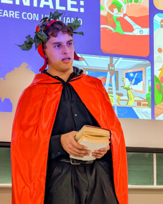 Colter dressed in a red cape and crown of leaves holds an ancient copy of the Divine Comedy