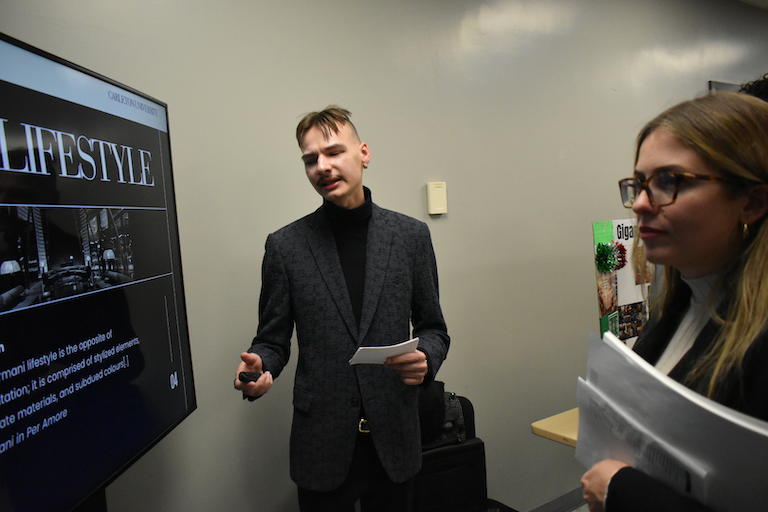 Kristian dressed in a fashionable grey sports coat and black turtleneck.
