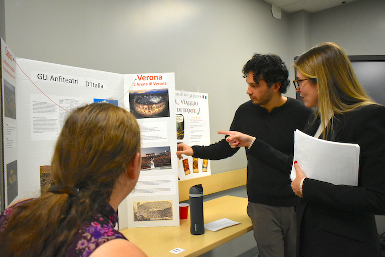 Timothy explains the amphiteatres of Italy while Aurora and Rebecca look on.