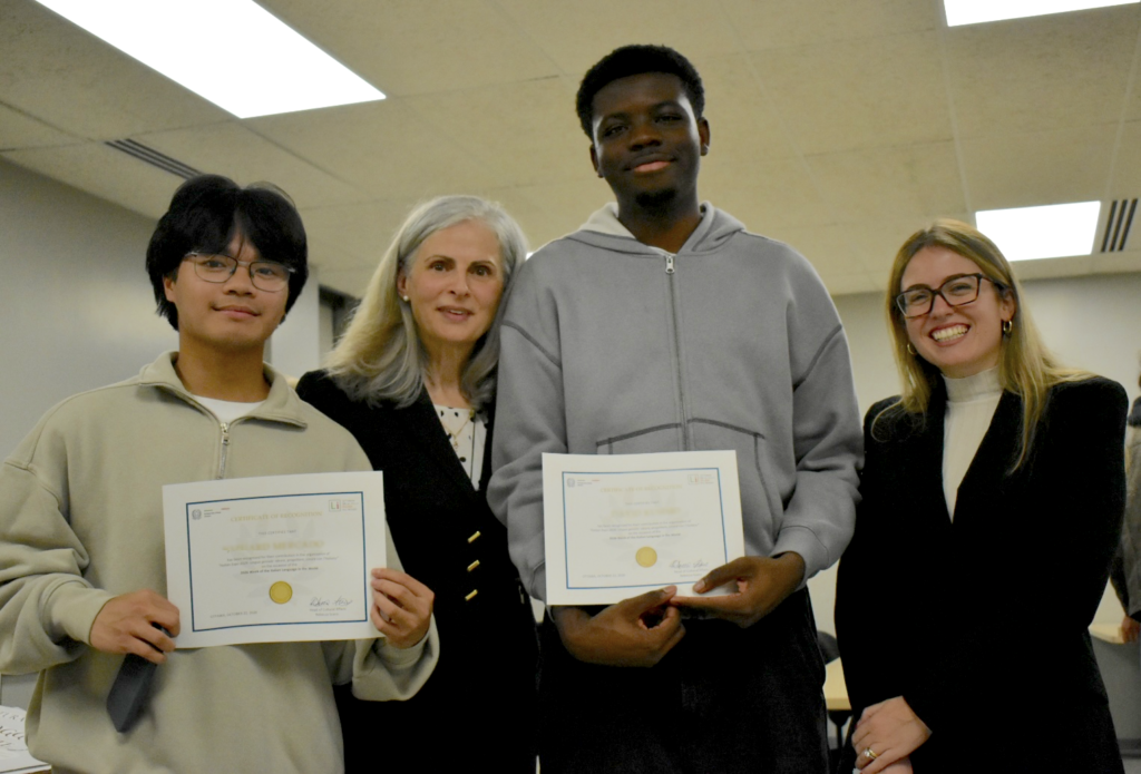 Jozuard and David stand with Claudia and Rebecca after receiving their certificates.