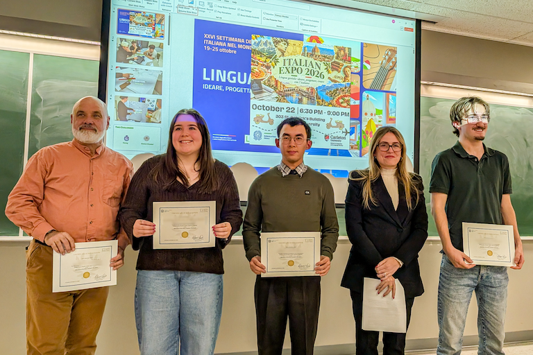 Group of prizewinners standing at the front of the classroom.