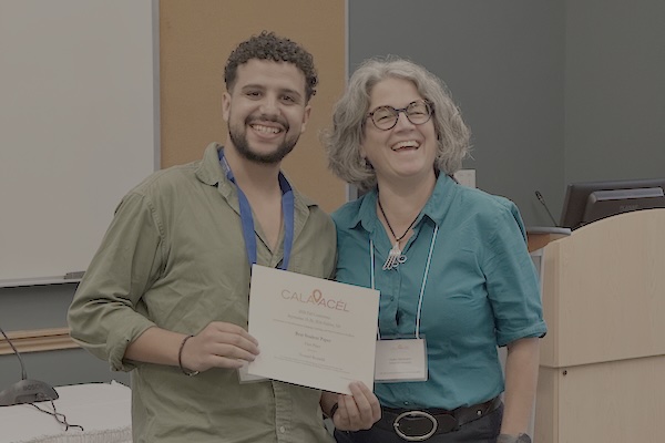 Youssef poses with certificate alongside Heike Neumann.
