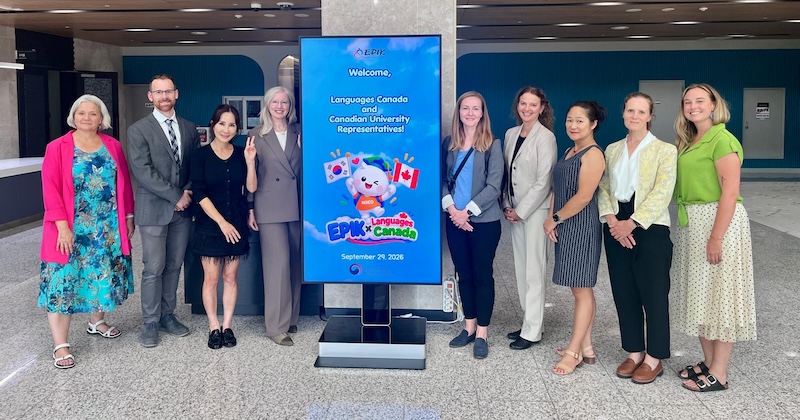 Delegation in front of sign: Welcome, Languages Canada and Canadian University. EPIK x Languages Canada