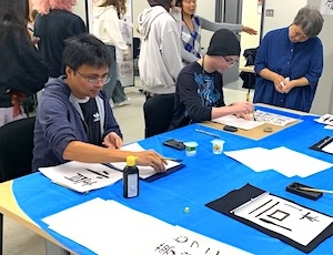 Students working on their calligraphy