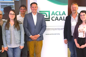 Photo of group standing in front of CAAL/ACLA sign.