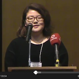 Student speaking at podium with microphones